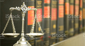 The scales of justice in front of books