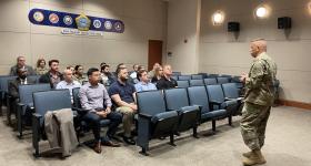 Students listening to a military man