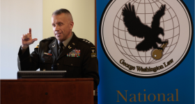 Lieutenant General Stuart W. Risch talking at a podium