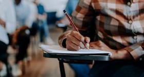 Adult writing in the classroom stock photo