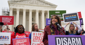 Ruth Glenn, president of Survivor Justice Action, addresses at a rally in front of the Supreme Court to call on the justices to disarm domestic violence perpetrators and protect survivors