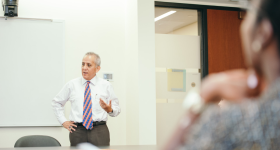 Professor Alberto Benitez teaching in a classroom