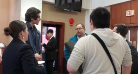 A group of students talk to a professor at the Adjunct Professor networking event.