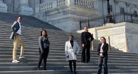 GW Law students stand on the steps at the U.S. Capitol.